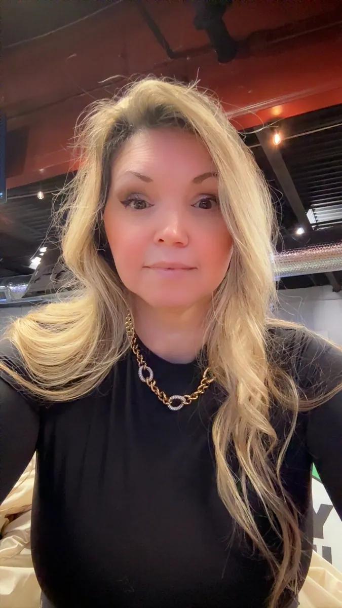 Danielle Lemons in a black top and gold chain. Danielle Lemons, Vice President of Operations at DirecTech Connect, in a black top with a gold chain necklace.
