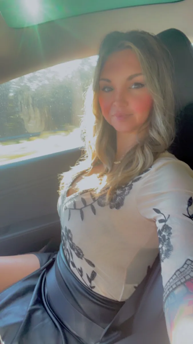 Danielle Lemons in an embroidered white blouse. Danielle Lemons, Vice President of Operations at DirecTech Connect, in a white blouse with black floral embroidery.