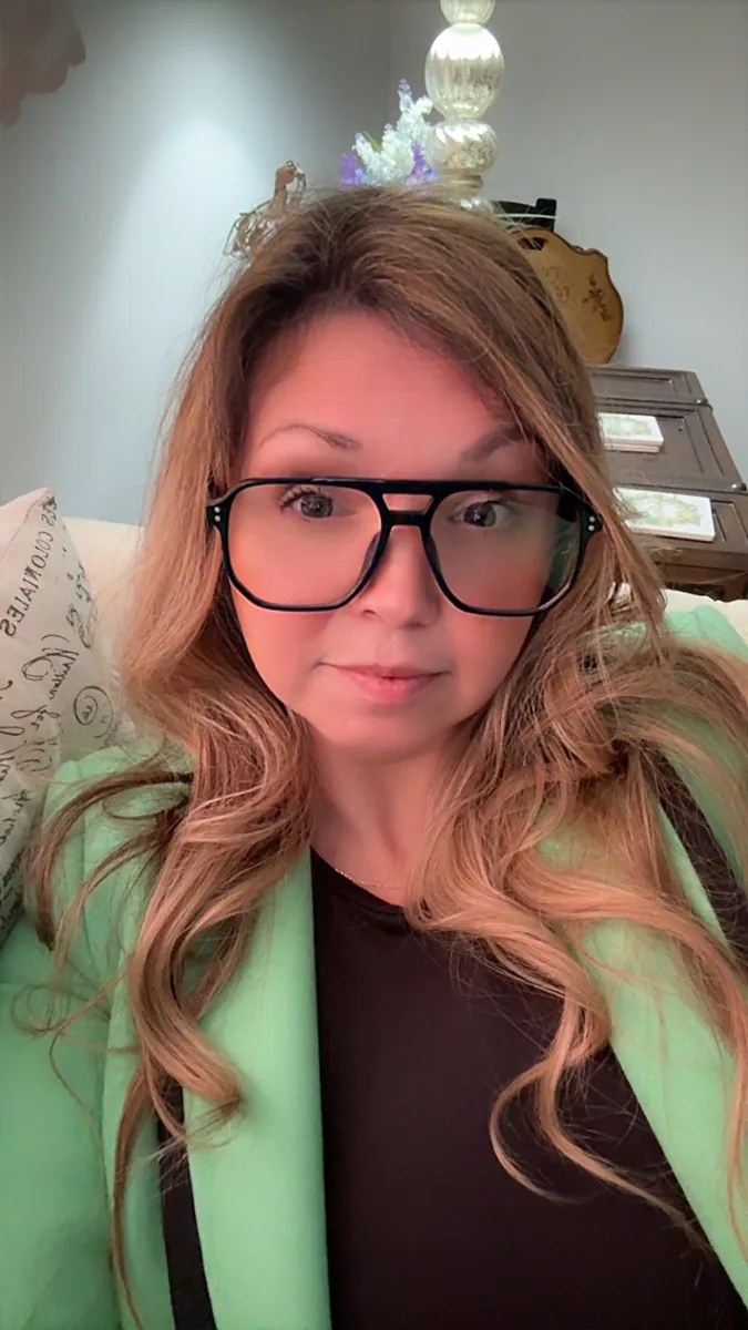 Danielle Lemons in glasses and a green blazer. Danielle Lemons, Vice President of Operations at DirecTech Connect, in glasses and a green blazer.