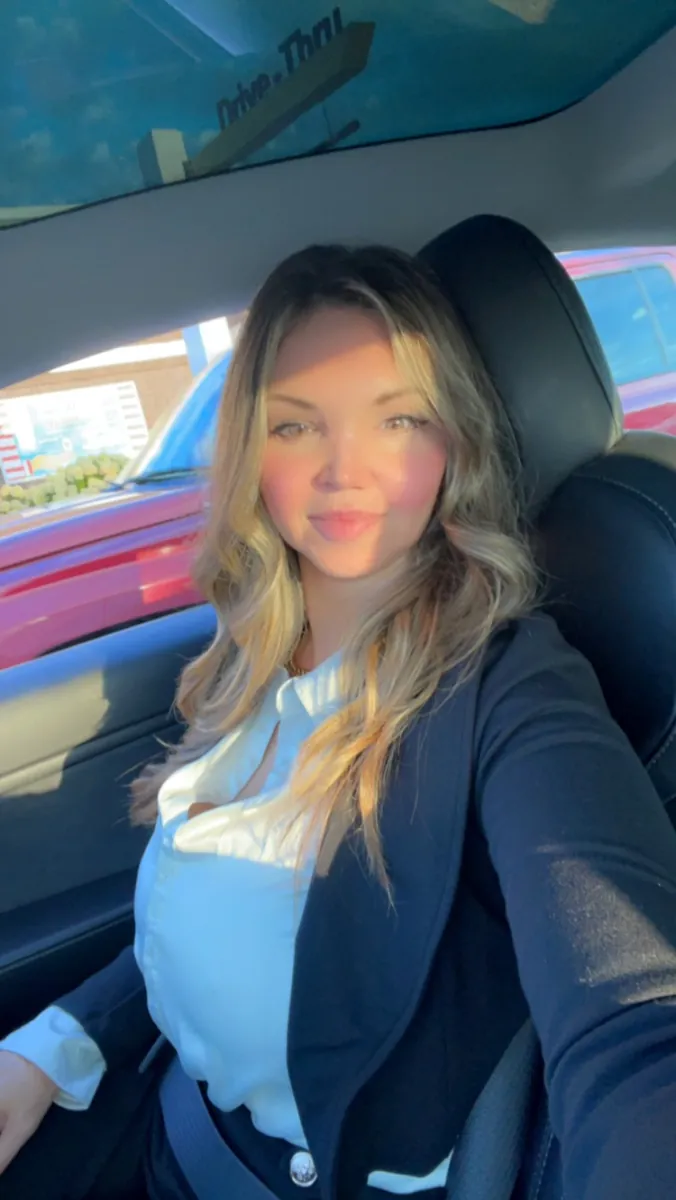 Danielle Lemons in a navy blazer. Danielle Lemons, Vice President of Operations at DirecTech Connect, in a navy blazer on her way to work.